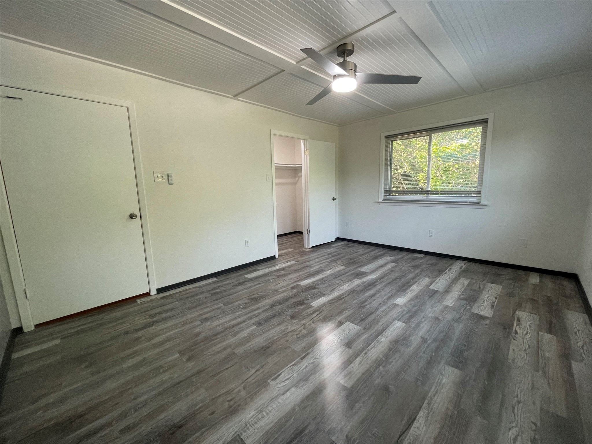 5802 Longhorn Landing Austin, TX 78734 - Photo 20 of 38 Unfurnished bedroom with dark wood-style floors and a ceiling fan