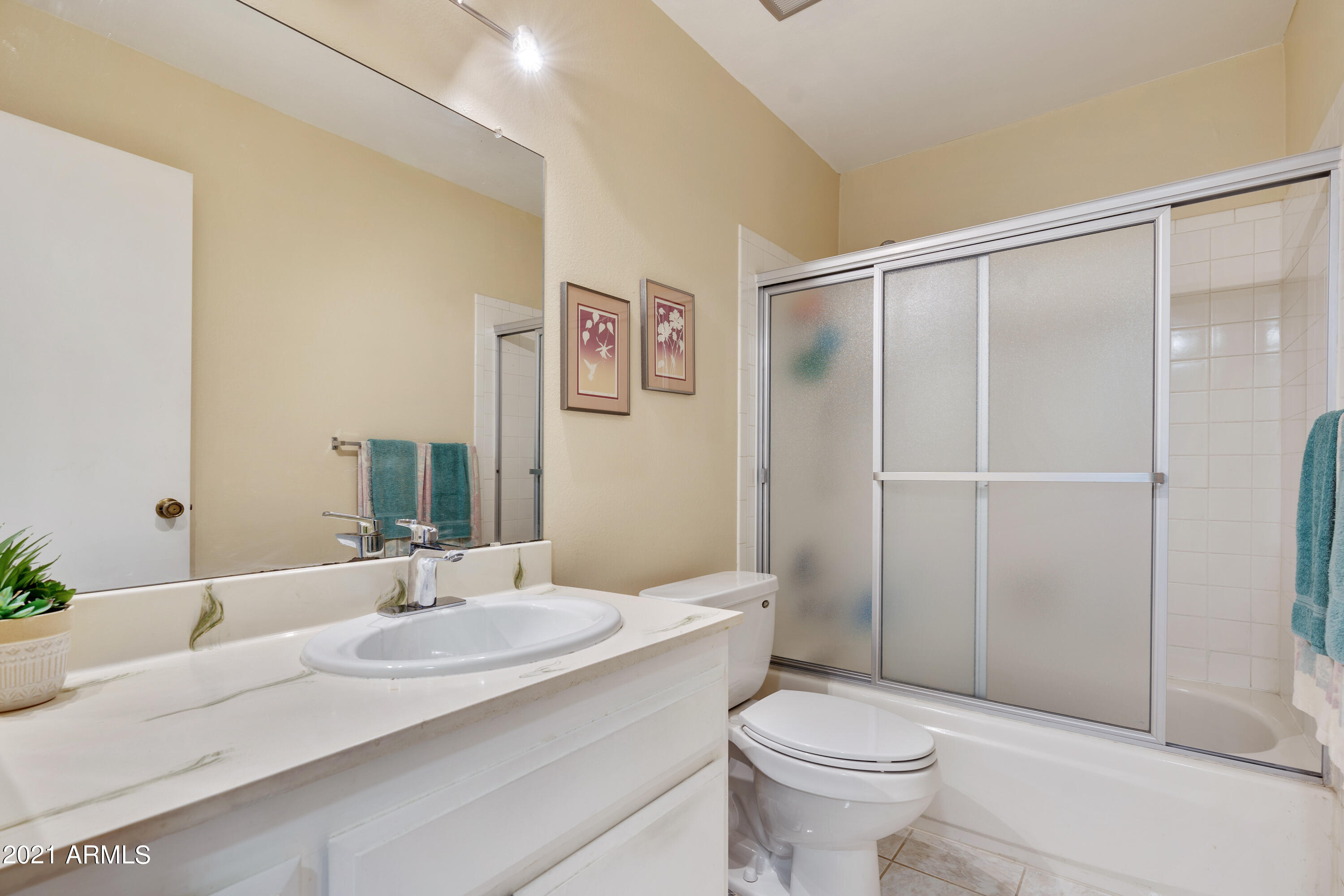 5525 East Thomas Road, Unit Q7 Phoenix, AZ 85018 - Photo 7 of 14 a bathroom with a granite countertop sink toilet and shower