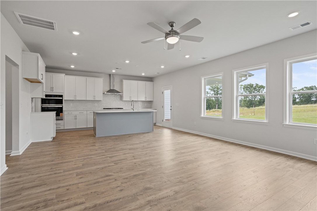 555 Hydrangea Street, Unit LOT 47 Seneca, SC 29678 - Photo 16 of 38 An open-concept living area with abundant natural light offers scenic outdoor views.