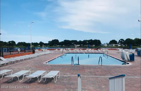 a view of a swimming pool with a lounge chairs