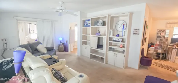 a living room with furniture and a book shelf