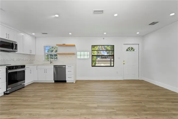 a view of a kitchen with microwave and cabinets