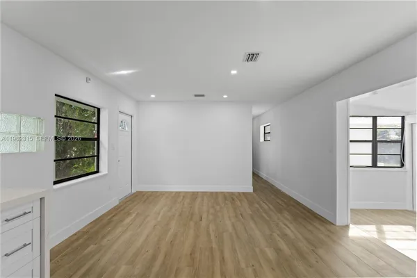 wooden floor in an empty room with a window