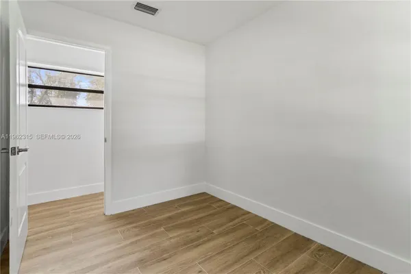 a view of a room with wooden floor