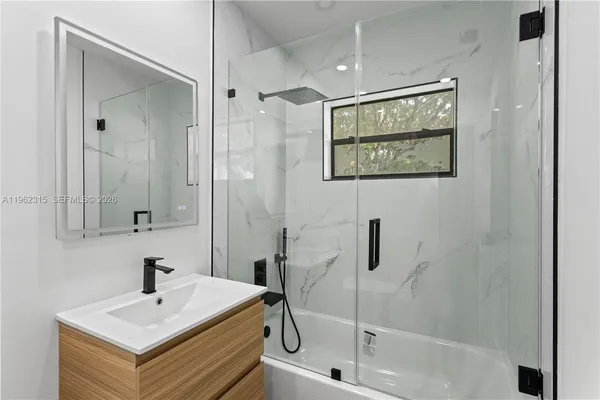 a bathroom with a bathtub and a sink