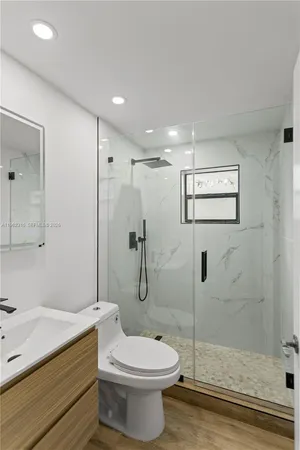 a bathroom with a toilet sink and shower