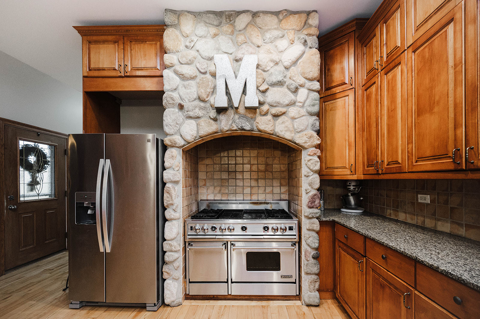 9S151 Granart Road Plano, IL 60545 - Photo 11 of 48 a kitchen with granite countertop a stove and a refrigerator