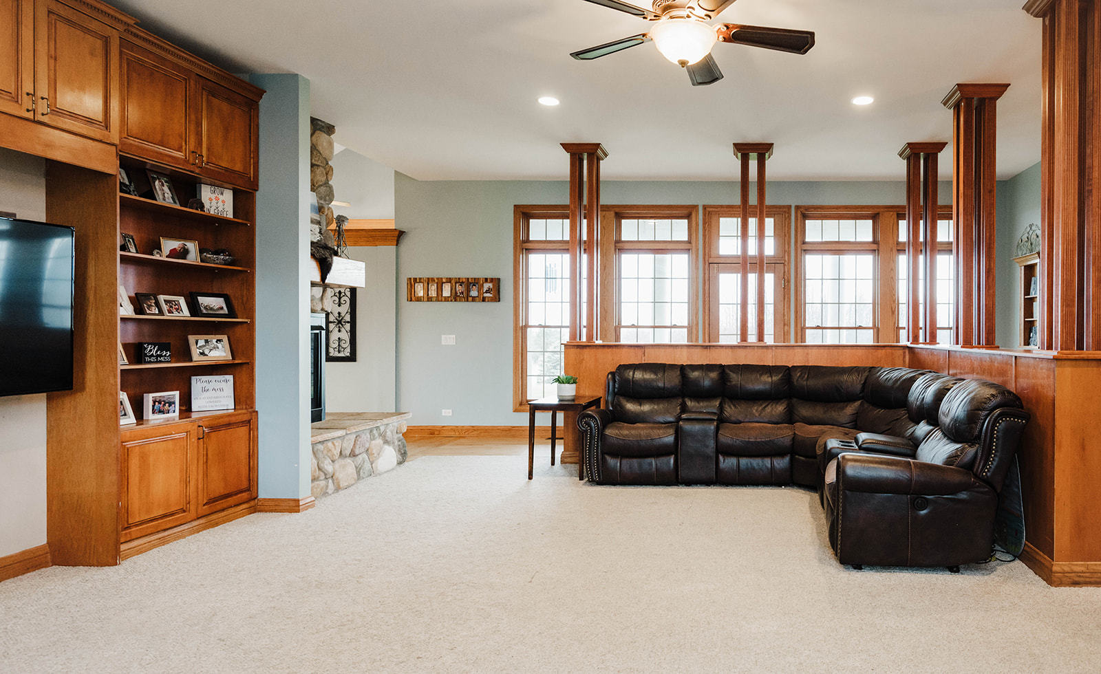 9S151 Granart Road Plano, IL 60545 - Photo 12 of 48 a living room with furniture a ceiling fan hardwood floor and a book shelf