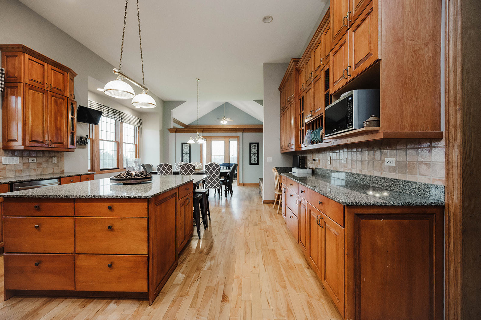 9S151 Granart Road Plano, IL 60545 - Photo 9 of 48 a kitchen with stainless steel appliances granite countertop a stove a sink dishwasher and microwave with wooden floor