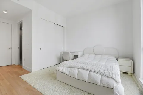 a bedroom with a bed and a walk in closet