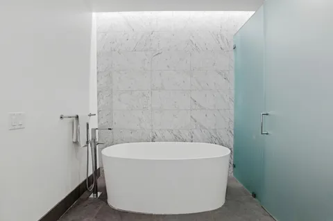a white bath tub sitting in a bathroom