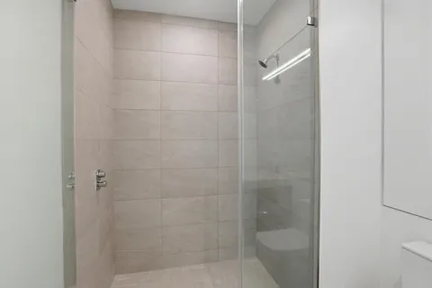 a bathroom with a shower and toilet