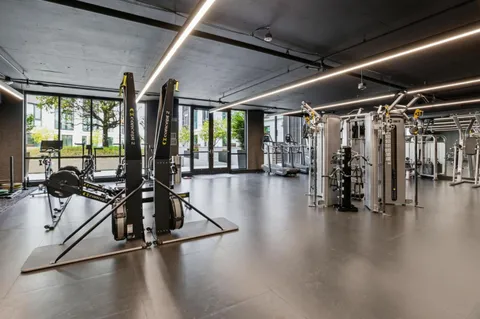 a view of a room with lots of wooden furniture and windows