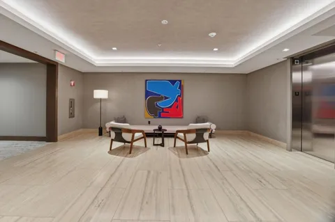 a view of a room with furniture and wooden floor