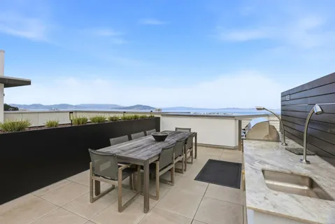 a terrace with outdoor seating and city view