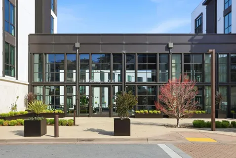 a view of a brick house with a fountain in front of it