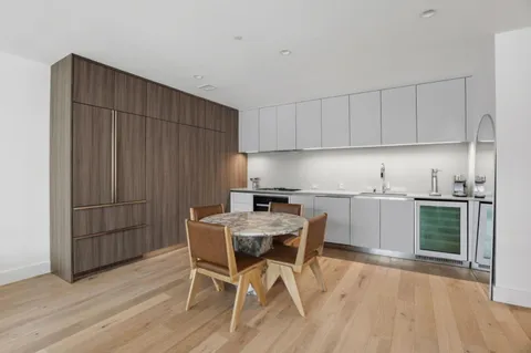 a view of a kitchen with a dining table and chairs