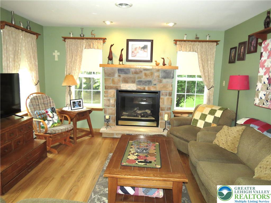 477 Quiet Valley Road Mount Bethel, PA 18343 - Photo 28 of 53 A comforting living area features a stone fireplace, creating an inviting focal point.