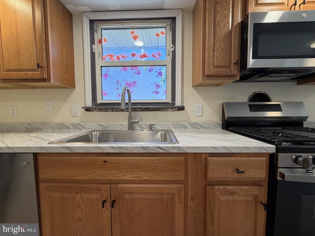 322 Nicholson Road Mount Ephraim, NJ 08059 - Photo 14 of 45 a kitchen with stainless steel appliances granite countertop a sink stove and microwave