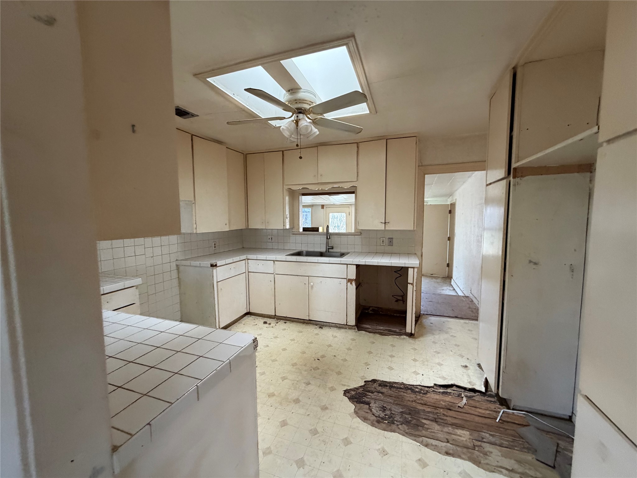 4420 Jester Drive Austin, TX 78704 - Photo 6 of 6 a white kitchen with a sink stainless steel appliances and cabinets