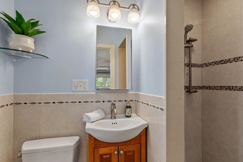 21 Potter Road Framingham, MA 01701 - Photo 26 of 42 a bathroom with a toilet a sink and a mirror