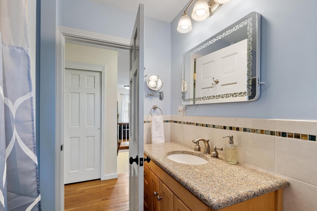 21 Potter Road Framingham, MA 01701 - Photo 31 of 42 a bathroom with a granite countertop sink vanity and mirror