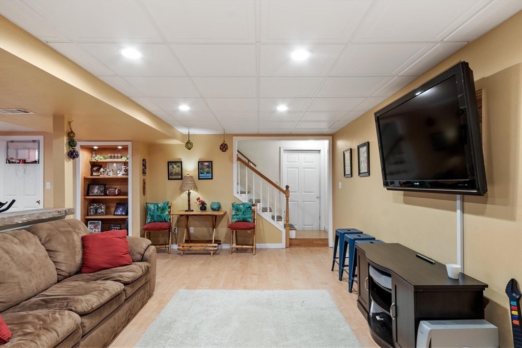 21 Potter Road Framingham, MA 01701 - Photo 33 of 42 a living room with furniture and a flat screen tv