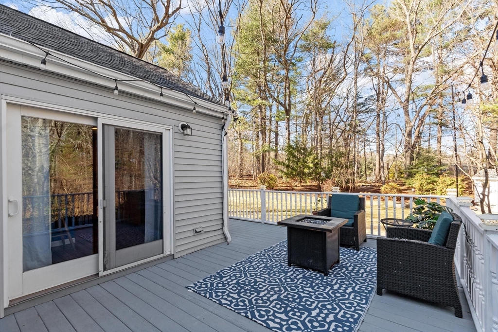 21 Potter Road Framingham, MA 01701 - Photo 36 of 42 a view of a patio with dining table and chairs with wooden floor and fence