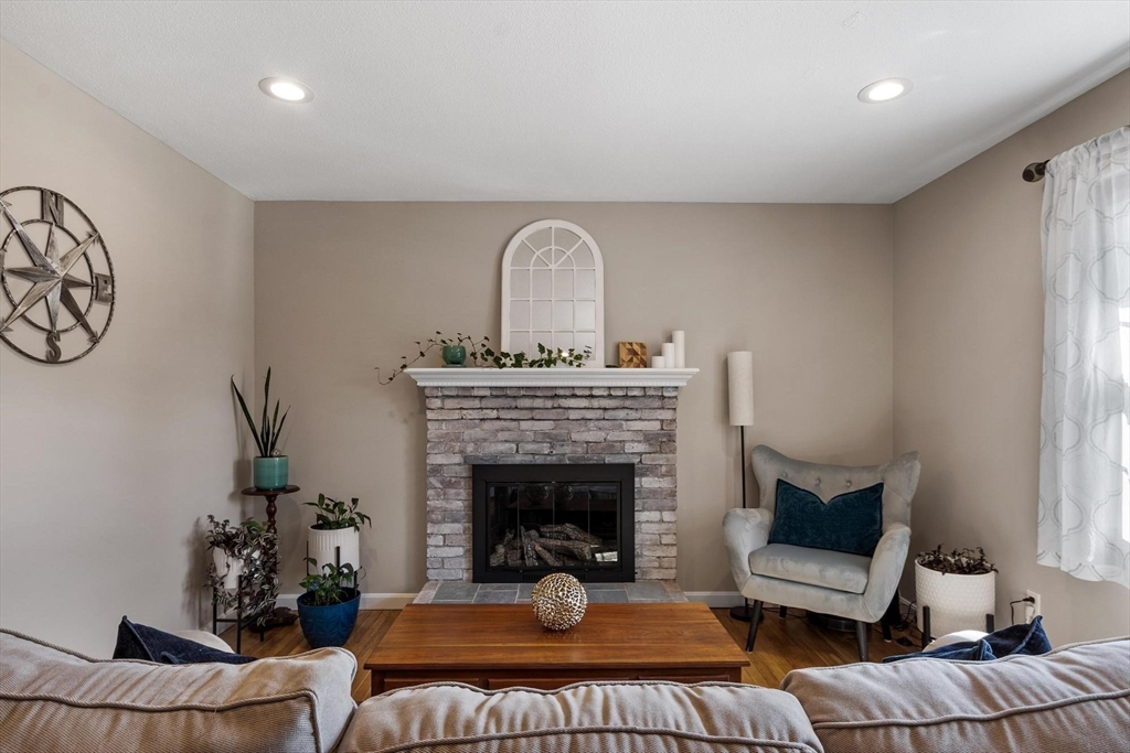 21 Potter Road Framingham, MA 01701 - Photo 5 of 42 a living room with furniture a fireplace and a window