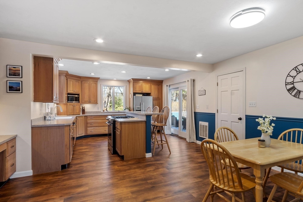 21 Potter Road Framingham, MA 01701 - Photo 6 of 42 a living room with furniture a dining table wooden floor and a kitchen view