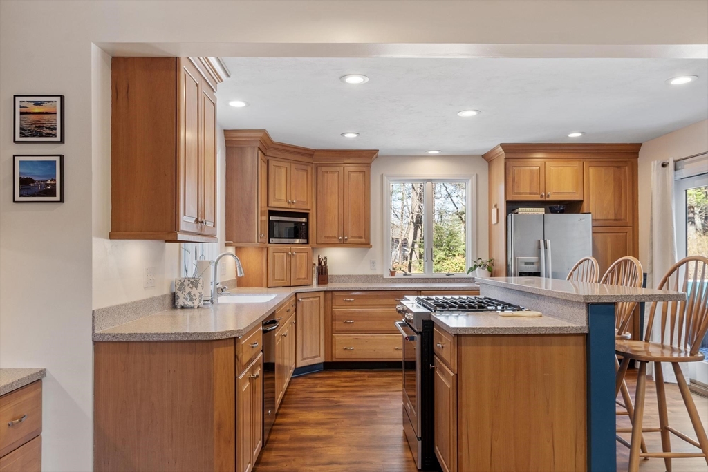 21 Potter Road Framingham, MA 01701 - Photo 8 of 42 a kitchen with stainless steel appliances granite countertop sink stove top oven and cabinets