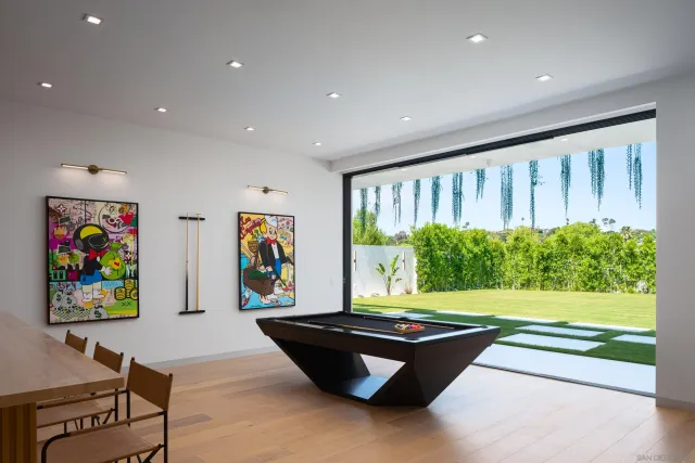 a living room with furniture and a projector screen