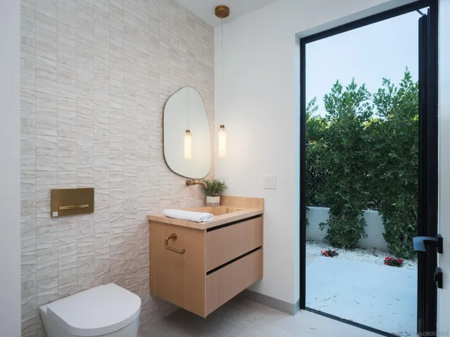 a living room with patio furniture and a floor to ceiling window