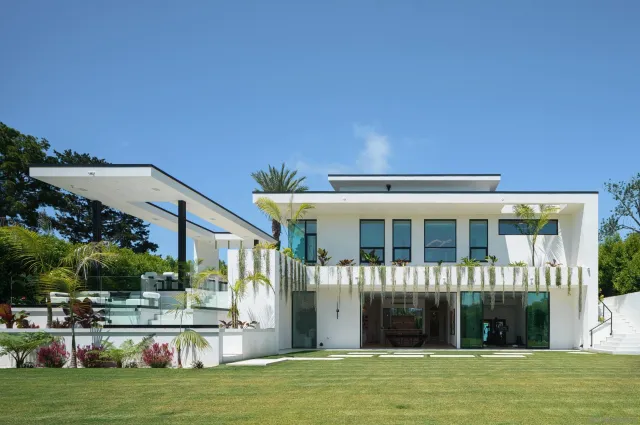a front view of a house with a garden