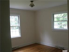 2435 Eaton Road Charlotte, NC 28205 - Photo 2 of 8 an empty room with wooden floor and windows