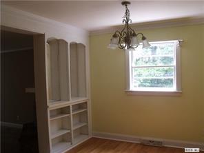 2435 Eaton Road Charlotte, NC 28205 - Photo 5 of 8 a front door view with a window and wooden floor