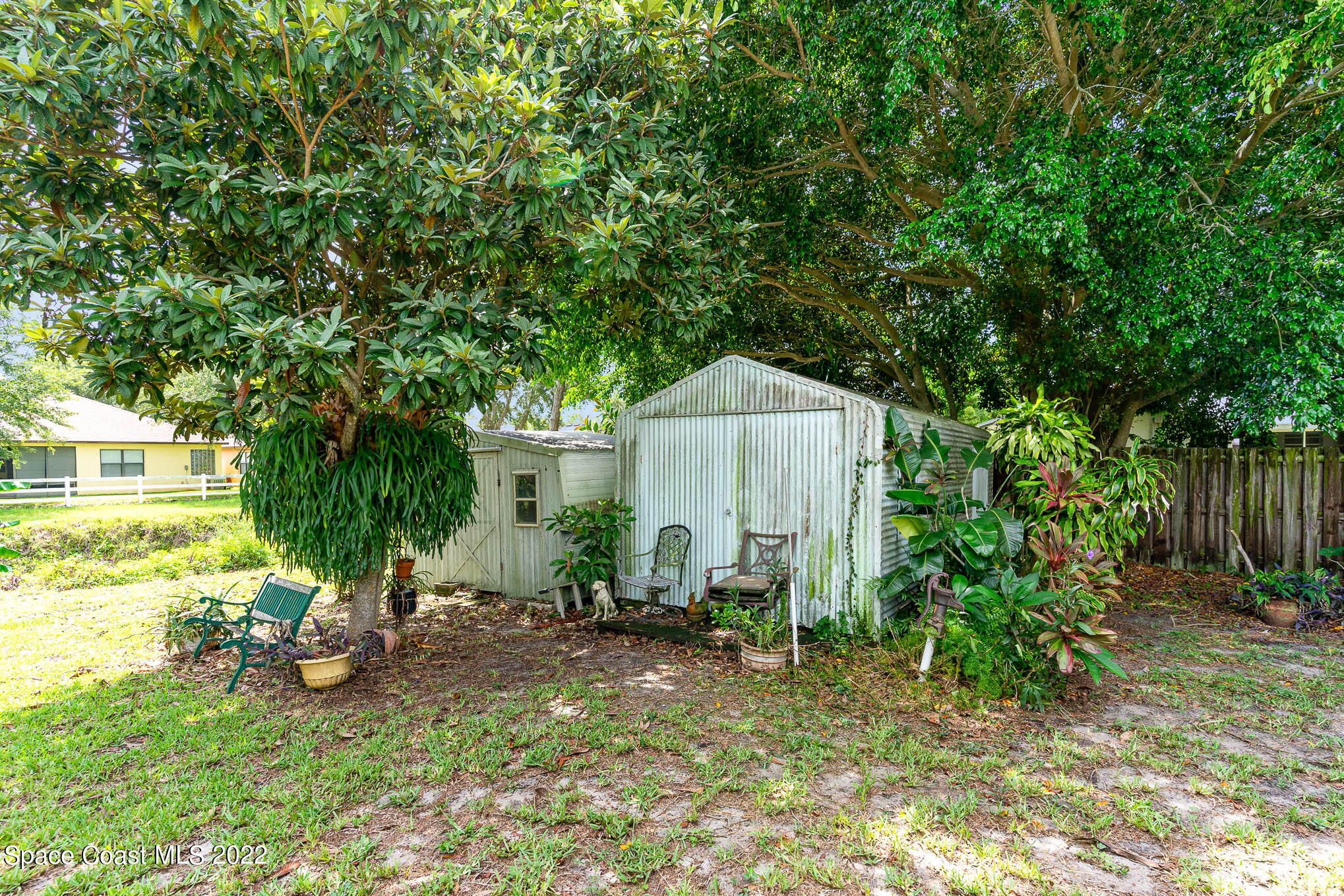 447 Count Street Melbourne, FL 32901 - Photo 19 of 24 a view of backyard with table and chairs and potted plants