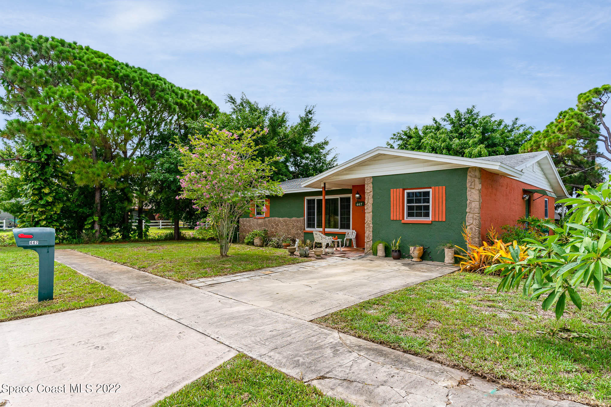447 Count Street Melbourne, FL 32901 - Photo 2 of 24 a front view of a house with a yard and trees