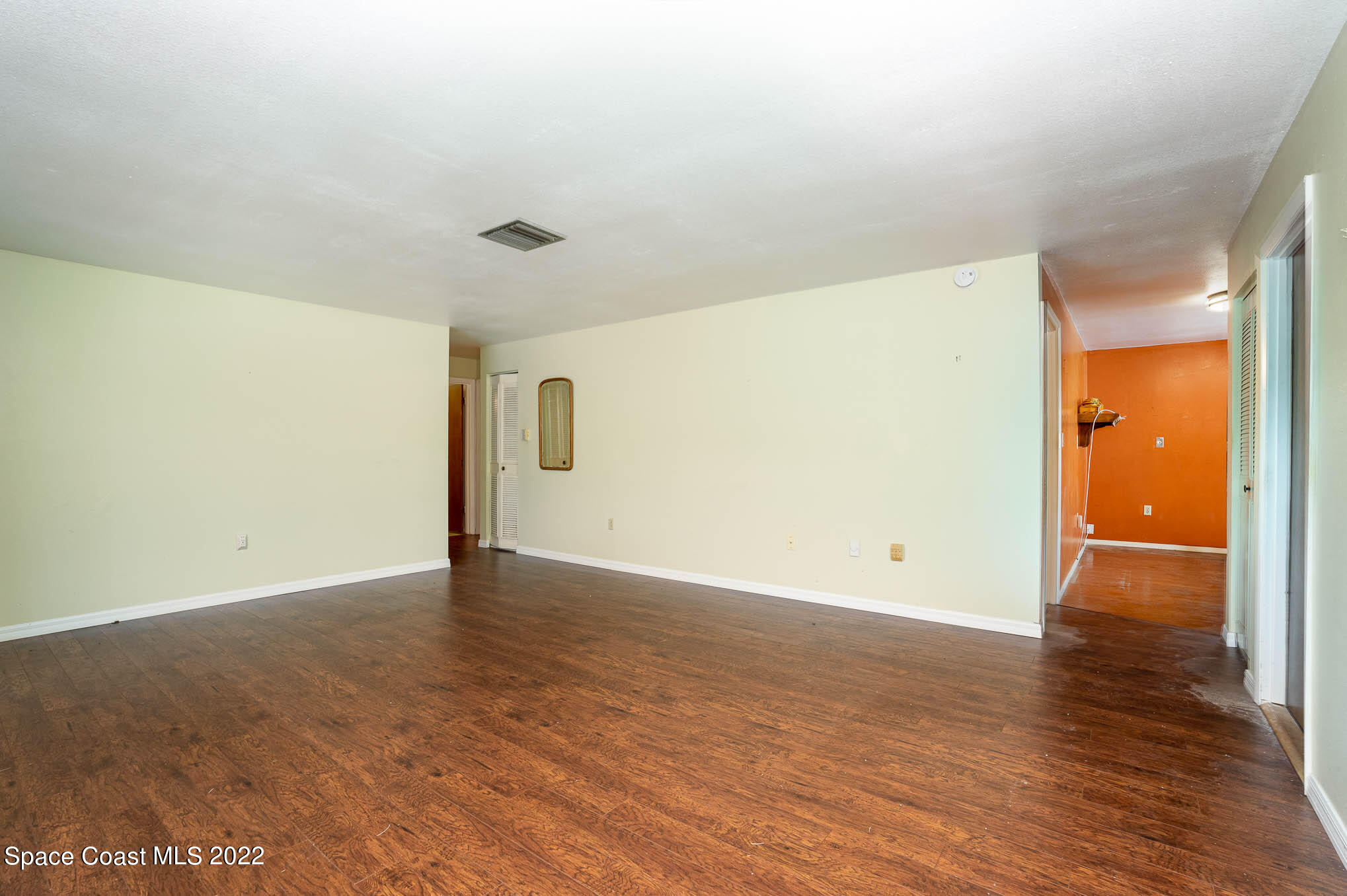 447 Count Street Melbourne, FL 32901 - Photo 3 of 24 a view of an empty room with wooden floor