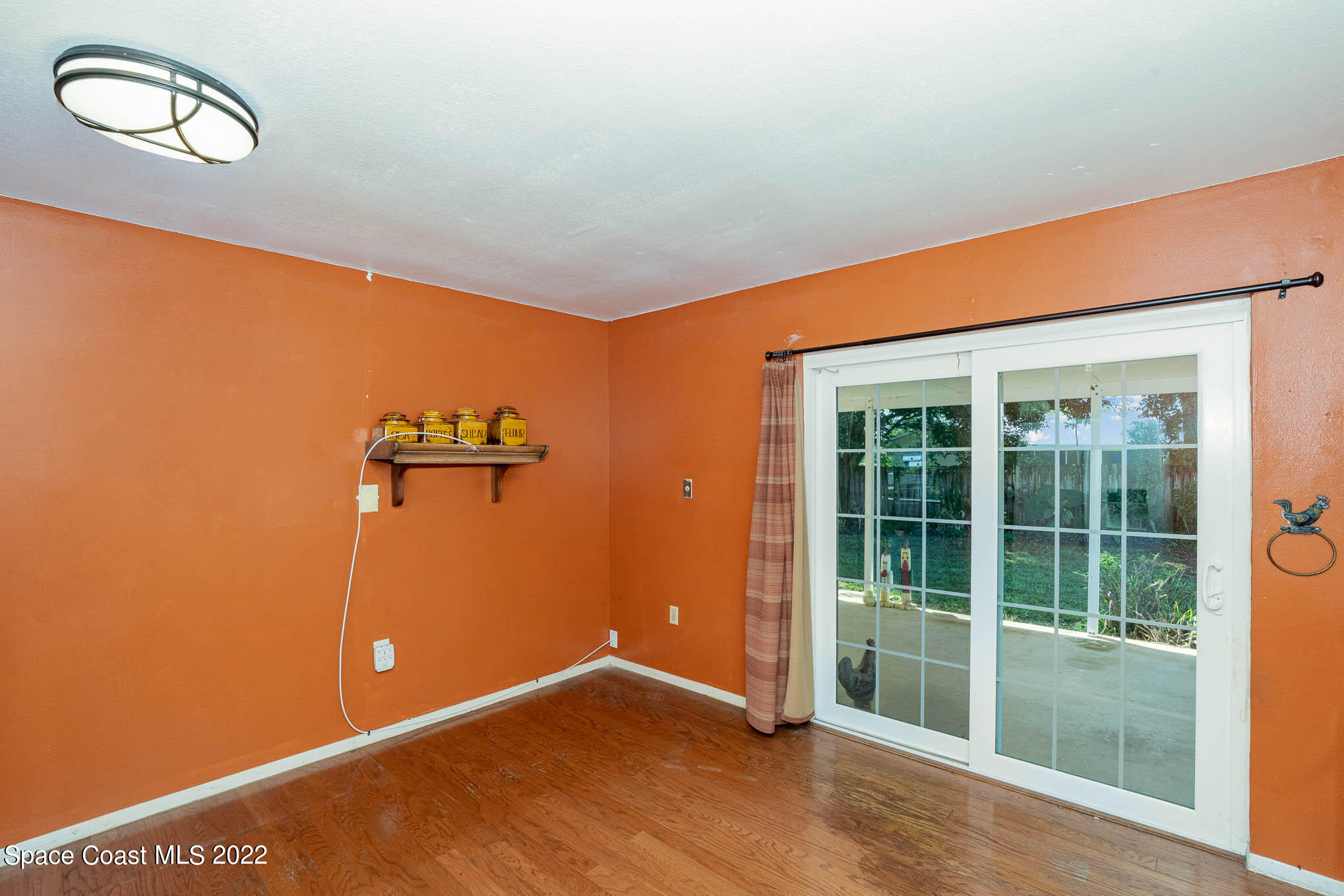 447 Count Street Melbourne, FL 32901 - Photo 8 of 24 an empty room with wooden floor and windows