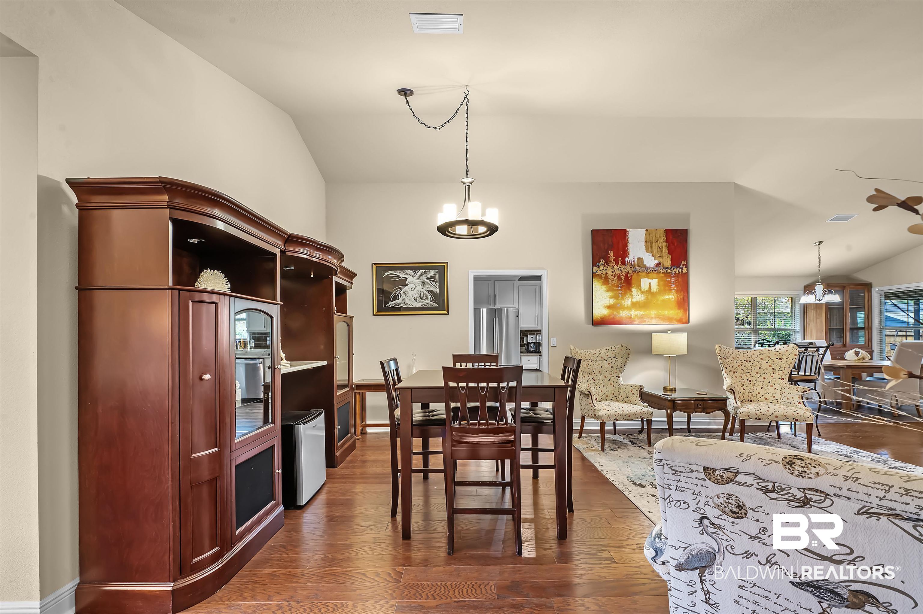 8896 Allay Lane Foley, AL 36535 - Photo 25 of 57 Dining space with vaulted ceiling, a chandelier, and dark hardwood / wood-style flooring