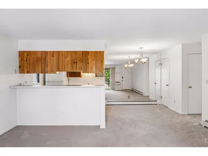 a view of kitchen with granite countertop cabinets and black stainless steel appliances