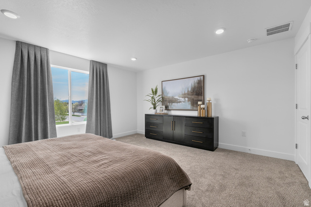 2819 South 710th West, Unit 14 Logan, UT 84321 - Photo 17 of 24 Spacious bedroom featuring a large window, recessed lighting, white trim, and neutral-toned carpeting