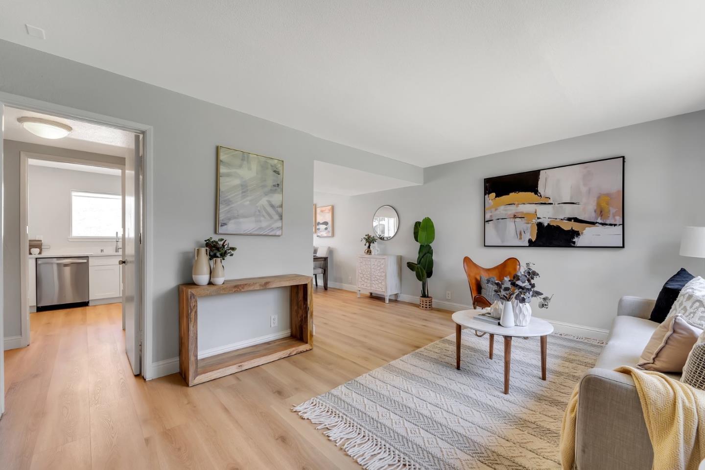 a living room with furniture a rug and a flat screen tv