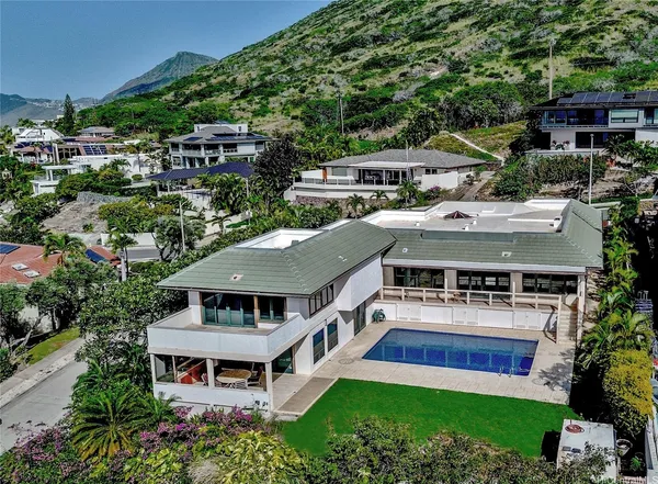 an aerial view of a house with a big yard
