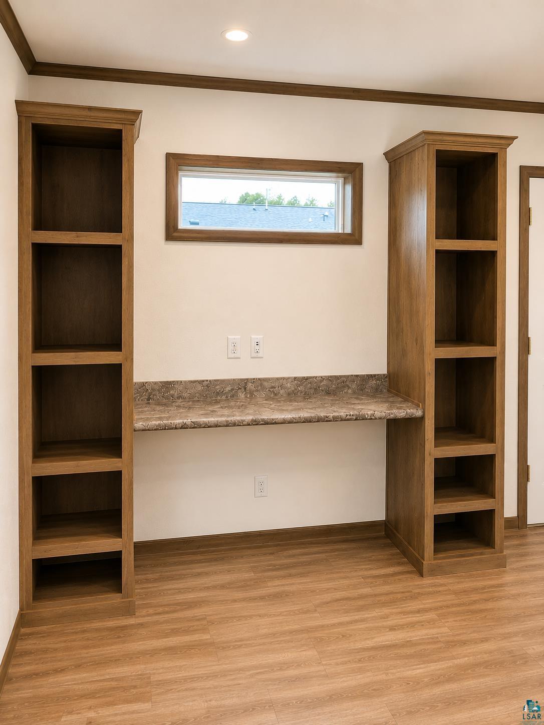 5051 Alpine Drive Hermantown, MN 55811 - Photo 7 of 24 Built-in desk area featuring a stone-look countertop, integrated shelving, and wood-finish flooring