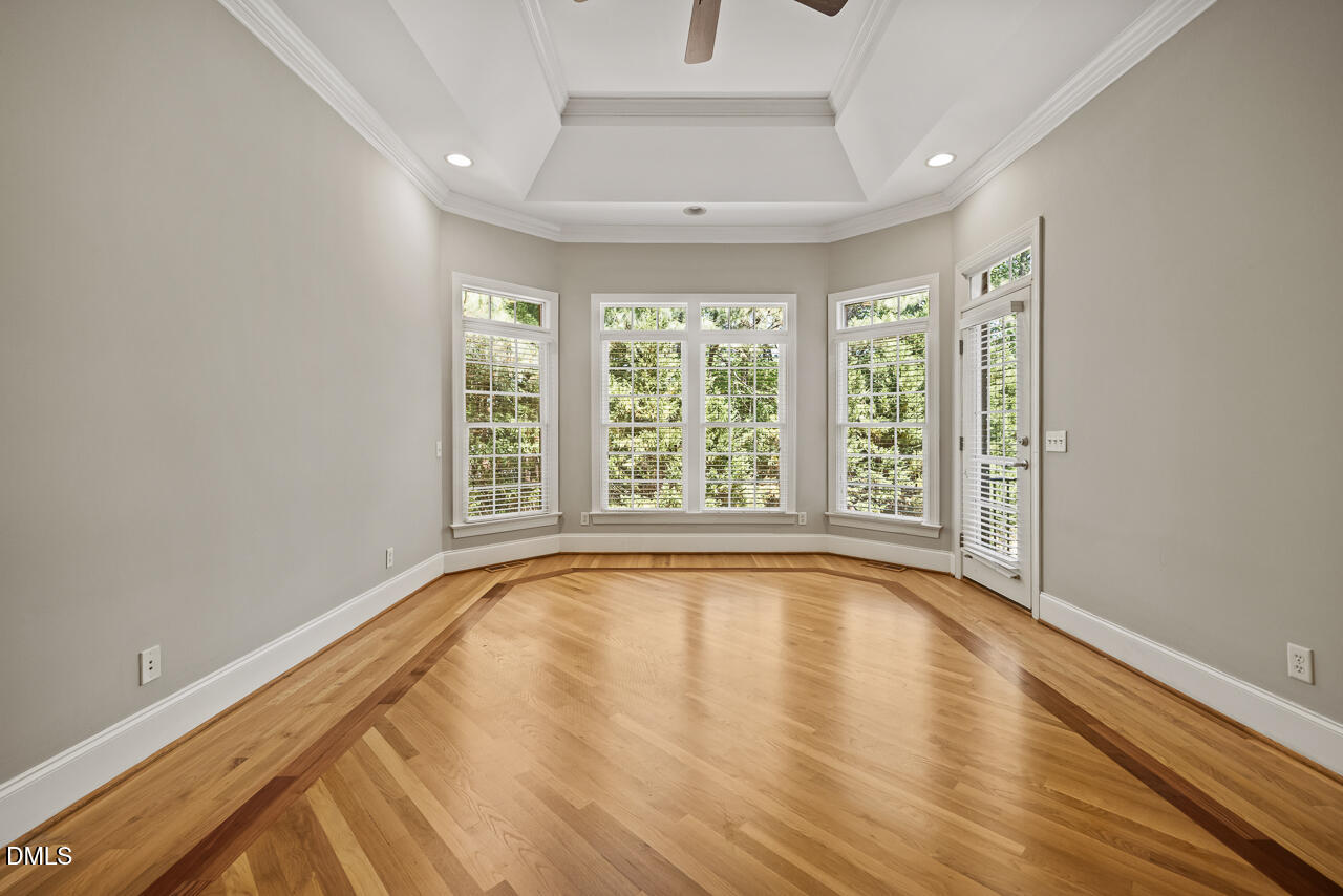 4004 Frontenac Court Apex, NC 27539 - Photo 26 of 61 a view of an empty room with wooden floor and a window