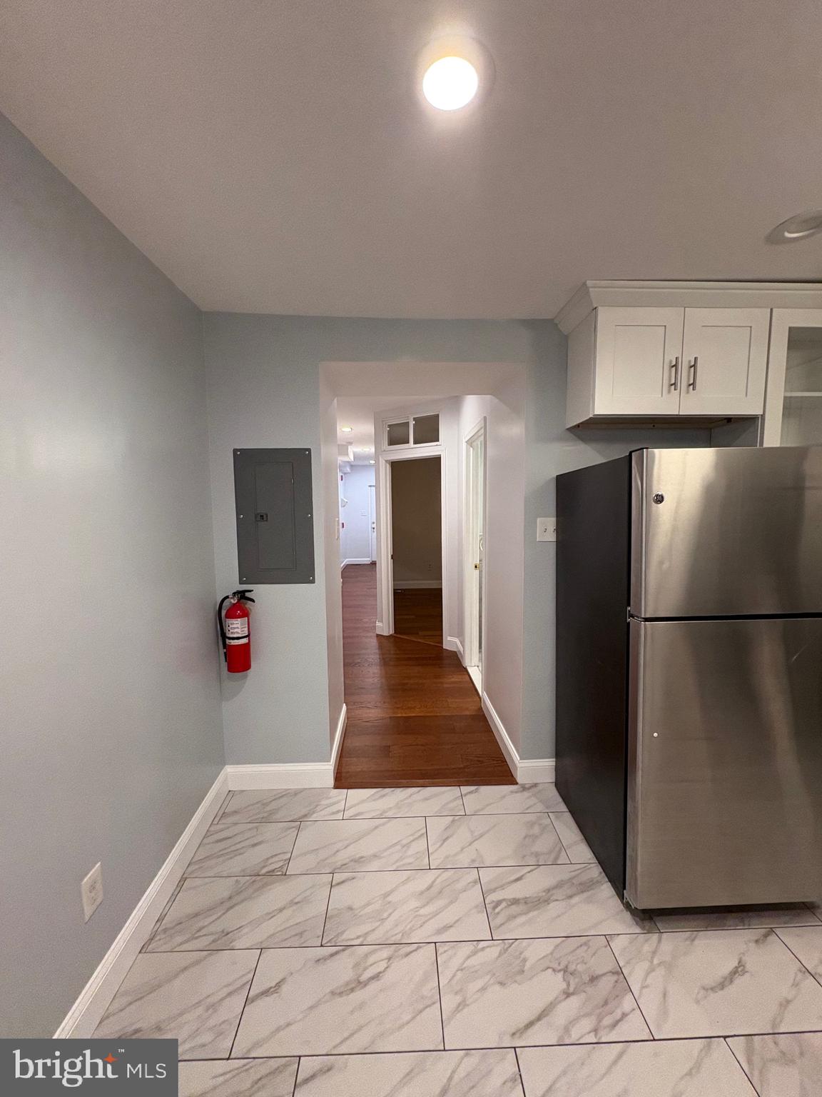 116 Grape Street, Unit 6 Philadelphia, PA 19127 - Photo 16 of 27 a view of a kitchen with wooden floor and a refrigerator