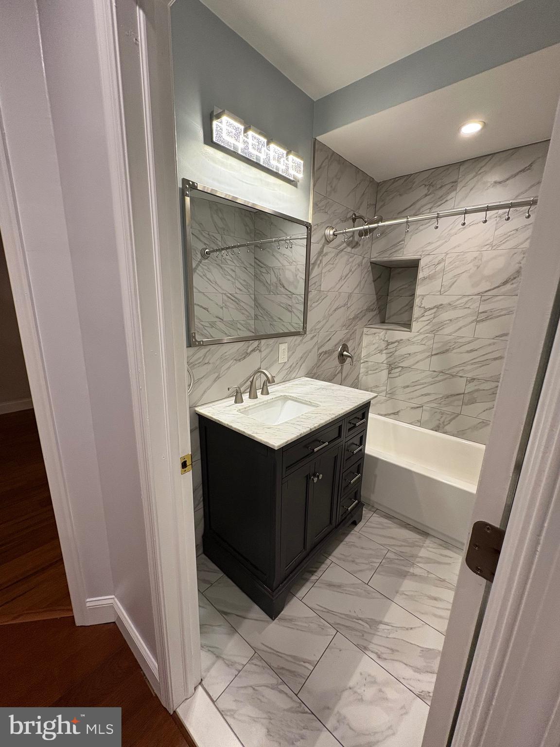 116 Grape Street, Unit 6 Philadelphia, PA 19127 - Photo 17 of 27 a bathroom with a sink and a mirror