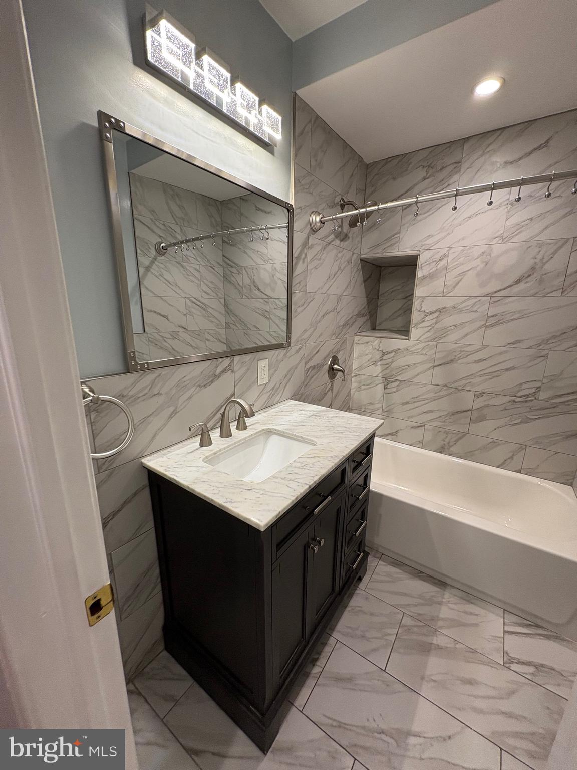 116 Grape Street, Unit 6 Philadelphia, PA 19127 - Photo 18 of 27 a bathroom with a sink mirror and a bathtub